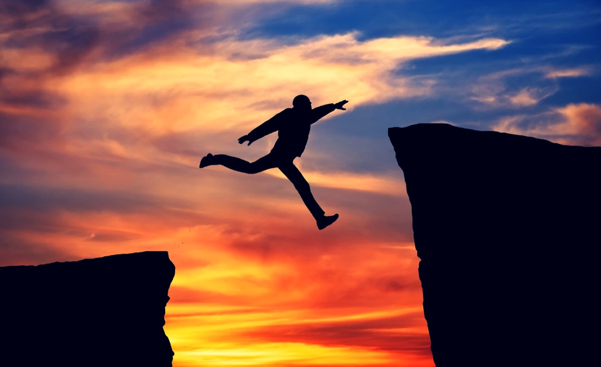 freepik-man-jumping-across-the-gap