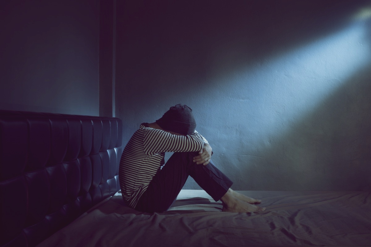 freepik-sad-man-on-the-bed-in-the-dark-room