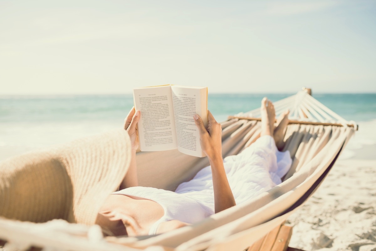freepik-woman-reading-book-in-hammock
